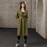 display of army-green hooded trench coat
